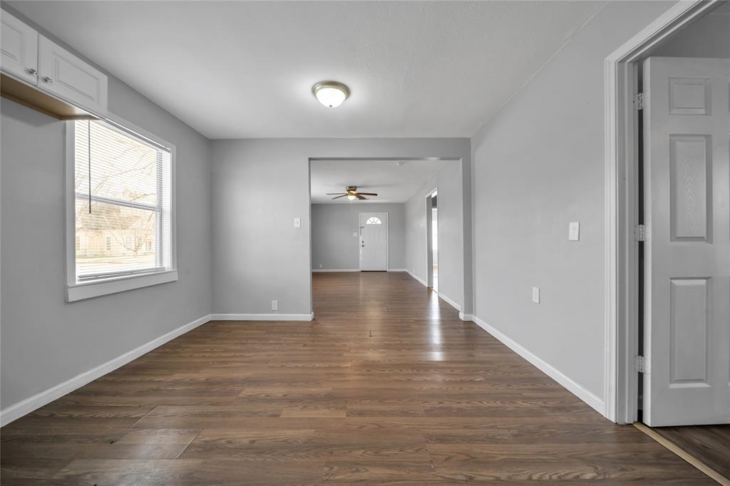901 Johnson Street Terrell, TX 75160 - Photo 13 of 21 a view of an empty room with wooden floor and a window