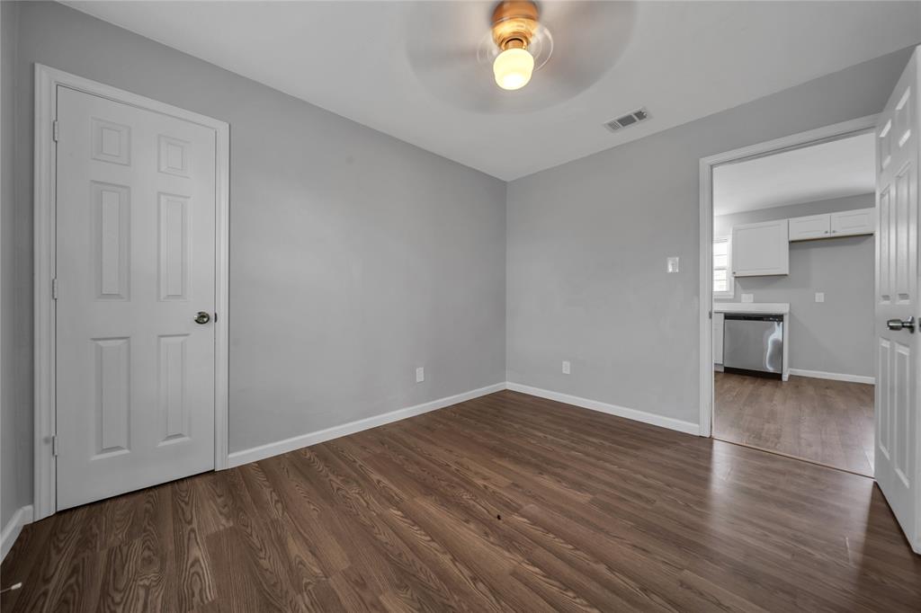 901 Johnson Street Terrell, TX 75160 - Photo 14 of 21 an empty room with wooden floor and windows