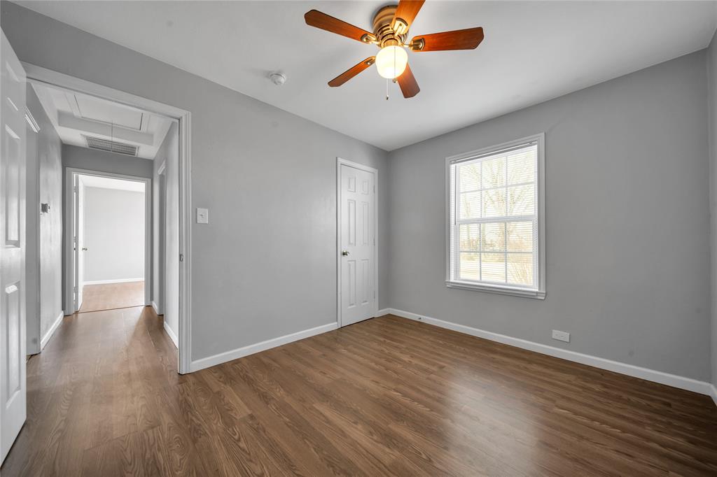 901 Johnson Street Terrell, TX 75160 - Photo 15 of 21 wooden floor in an empty room with a window