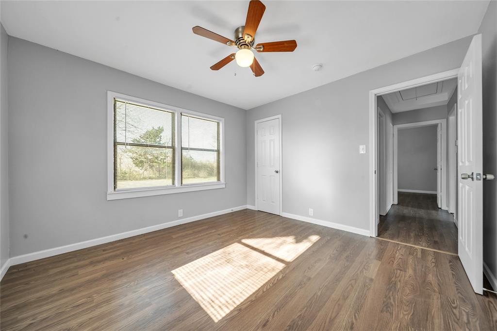 901 Johnson Street Terrell, TX 75160 - Photo 16 of 21 wooden floor in an empty room with a window