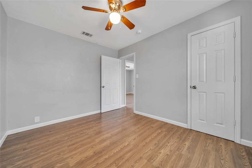 901 Johnson Street Terrell, TX 75160 - Photo 19 of 21 a view of an empty room with window and wooden floor