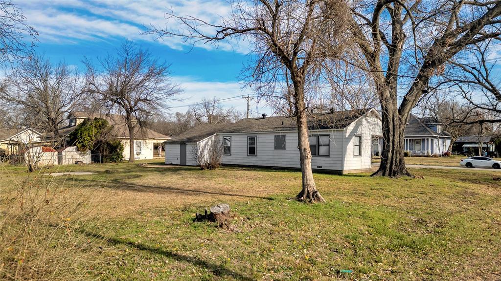901 Johnson Street Terrell, TX 75160 - Photo 5 of 21 a yellow house with trees in front of it