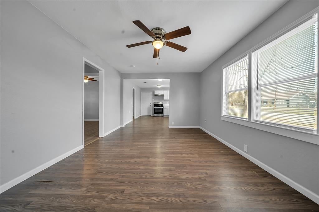 901 Johnson Street Terrell, TX 75160 - Photo 9 of 21 a view of empty room with wooden floor and ceiling fan