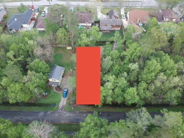 an aerial view of a house with a yard basket ball court and outdoor seating