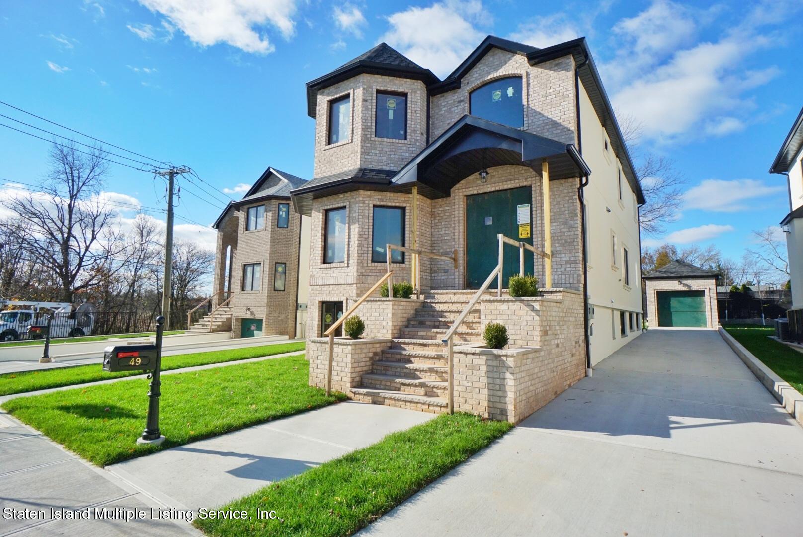 49 Torrice Loop Staten Island, NY 10309 - Photo 2 of 10 a front view of a house with a yard
