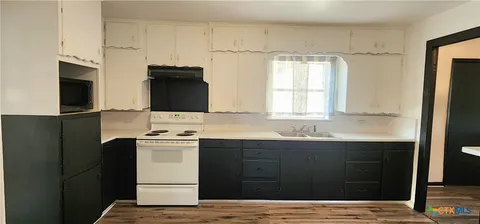 a kitchen with a sink and a refrigerator