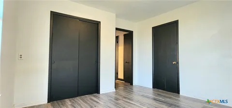 a view of hallway with wooden floor