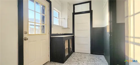 a view of a kitchen from the hallway