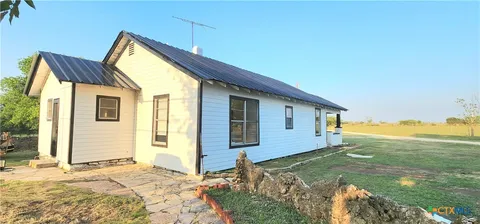 a view of a house with a backyard