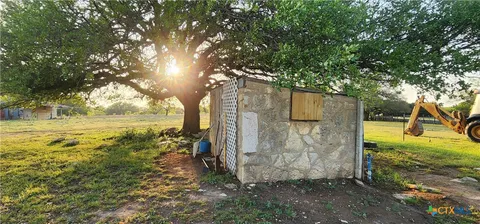 a view of a wooden house with a yard