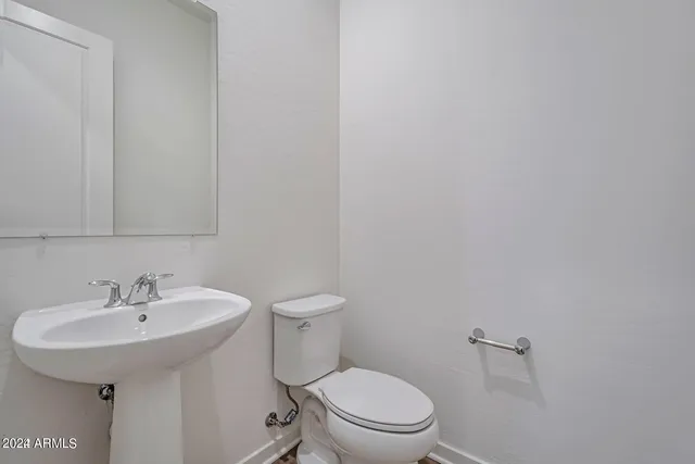 a white toilet sitting next to a white sink