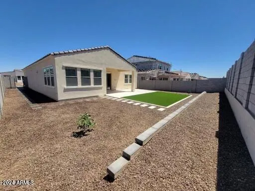 a view of a house with a backyard