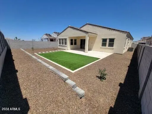 a view of a house with a backyard
