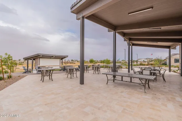 a view of a swimming pool with a couch and chairs