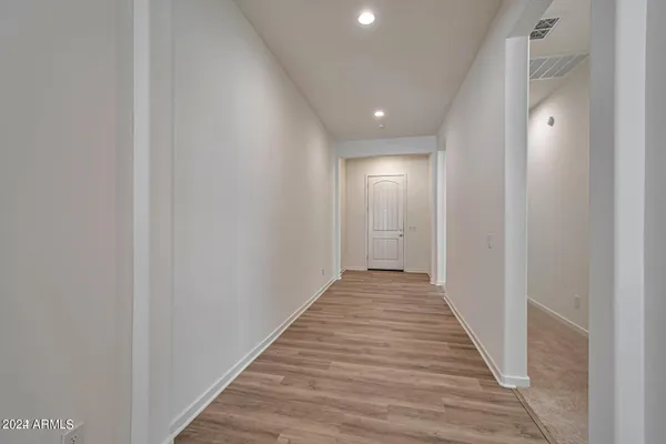 a view of a hallway with wooden floor