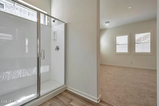 a bathroom with a glass shower door