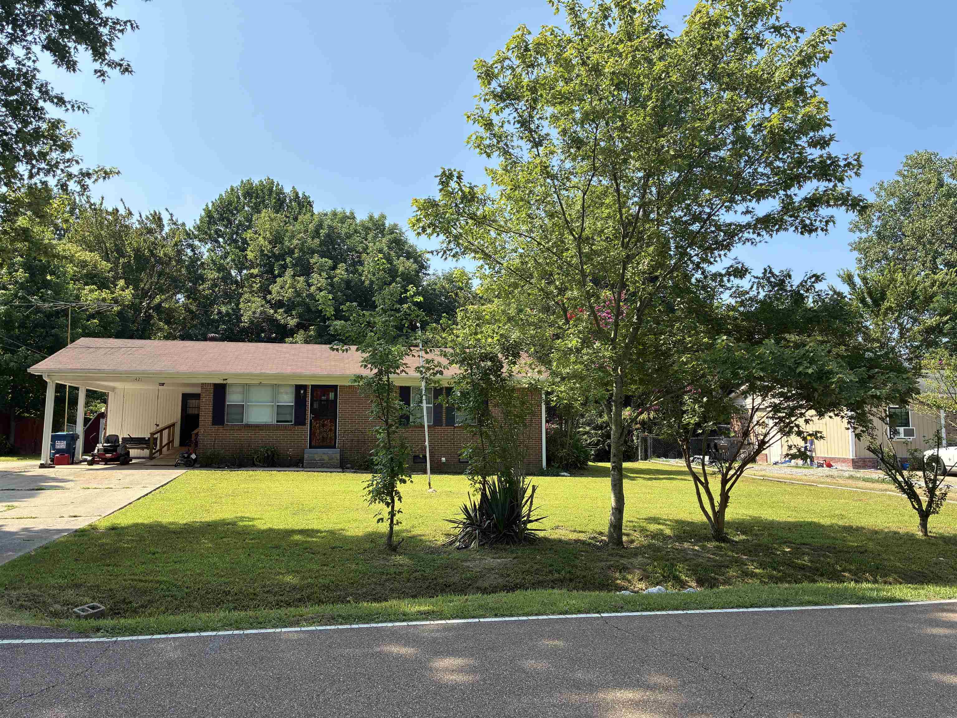 1421 Central Curve Road Ripley, TN 38063 - Photo 1 of 17 Ranch-style home featuring an attached carport, concrete driveway, brick siding, and a front yard