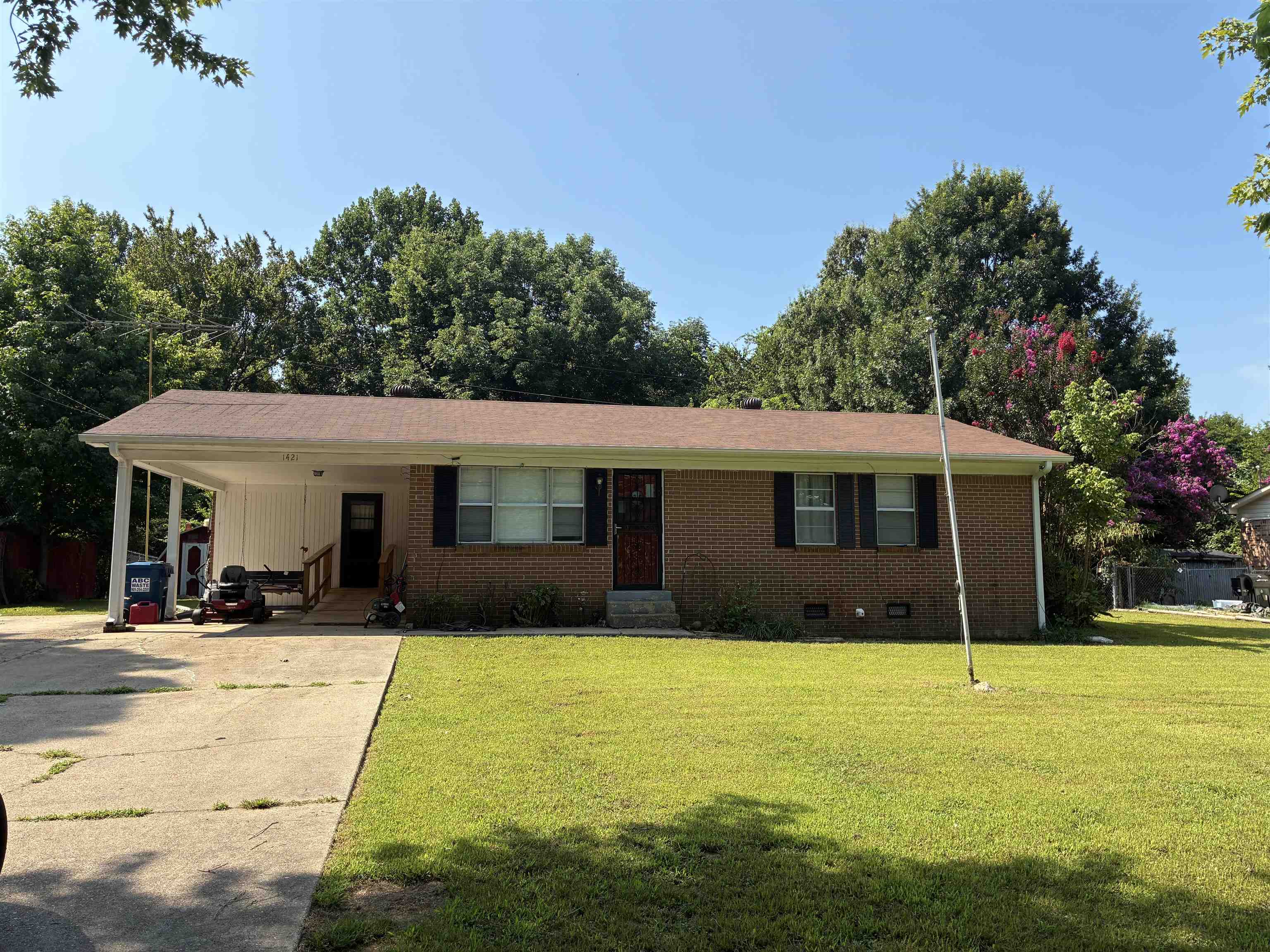 1421 Central Curve Road Ripley, TN 38063 - Photo 2 of 17 Ranch-style house featuring a carport, concrete driveway, crawl space, a front lawn, and brick siding