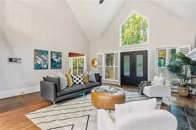 a living room with furniture and a wooden floor