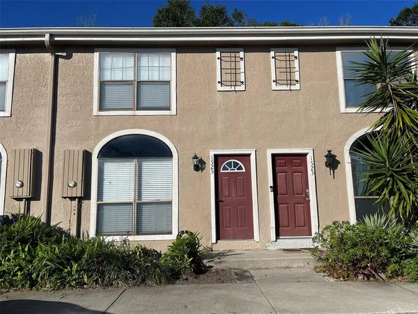 a front view of a house with plants