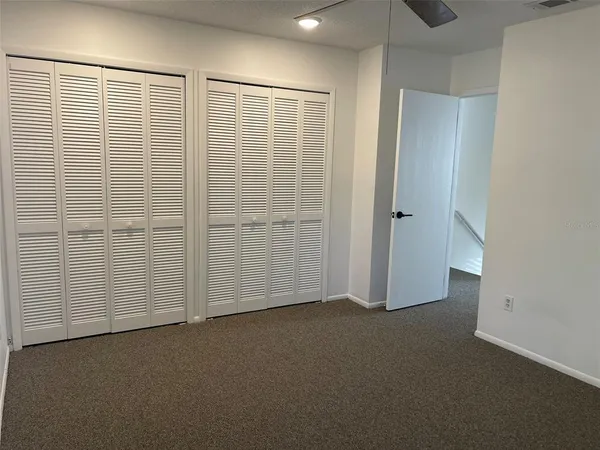 a view of an empty room with closet