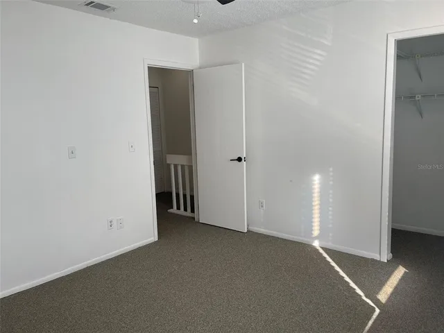 an empty room with closet area