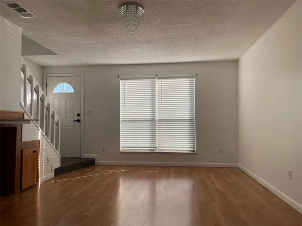 an empty room with a fireplace and windows
