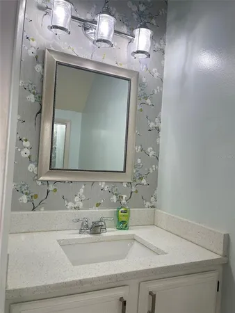 a bathroom with a sink and a mirror