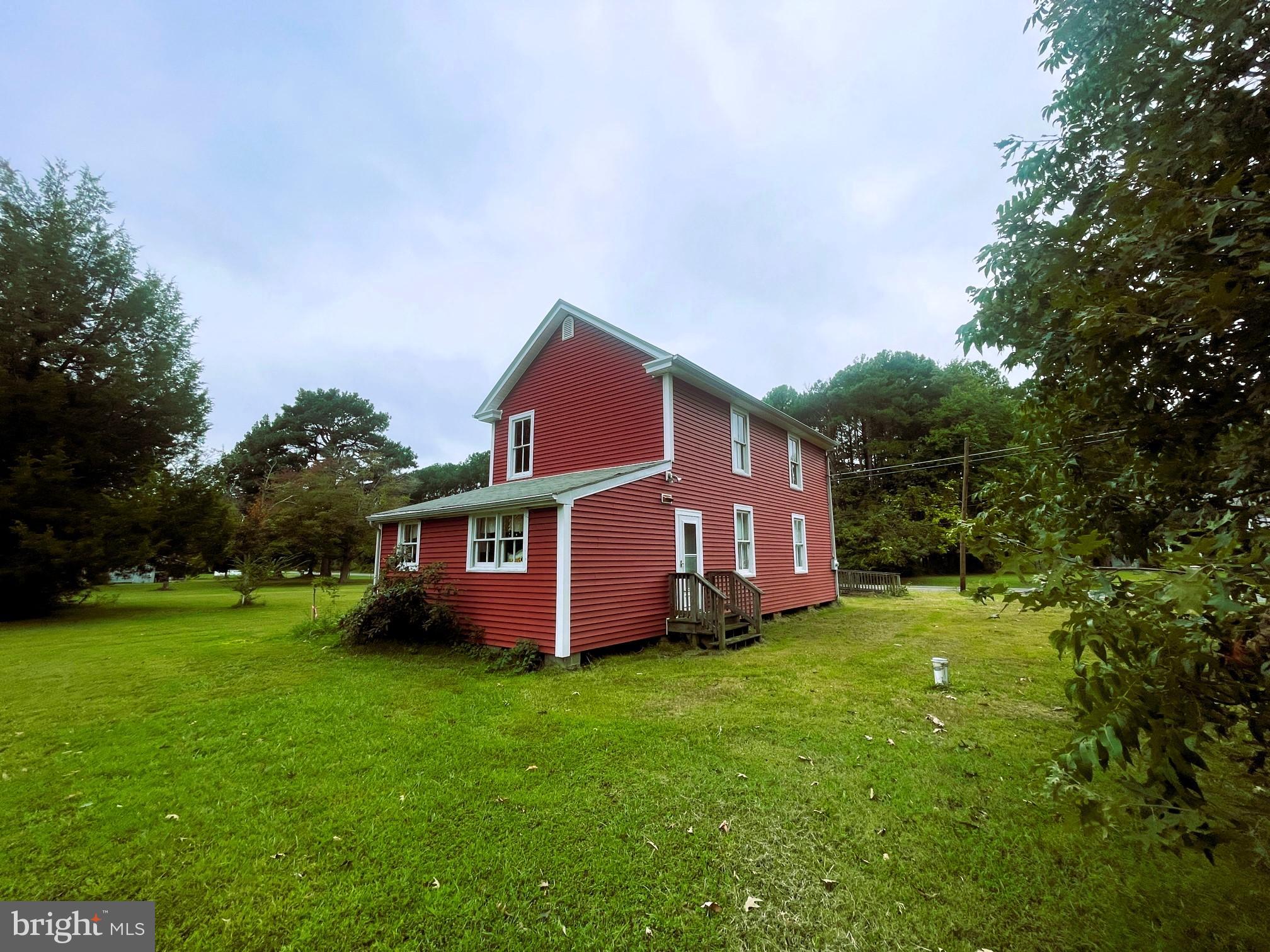 7983 Bozman Neavitt Road Bozman, MD 21612 - Photo 5 of 5 a view of a house with a big yard potted plants and large tree