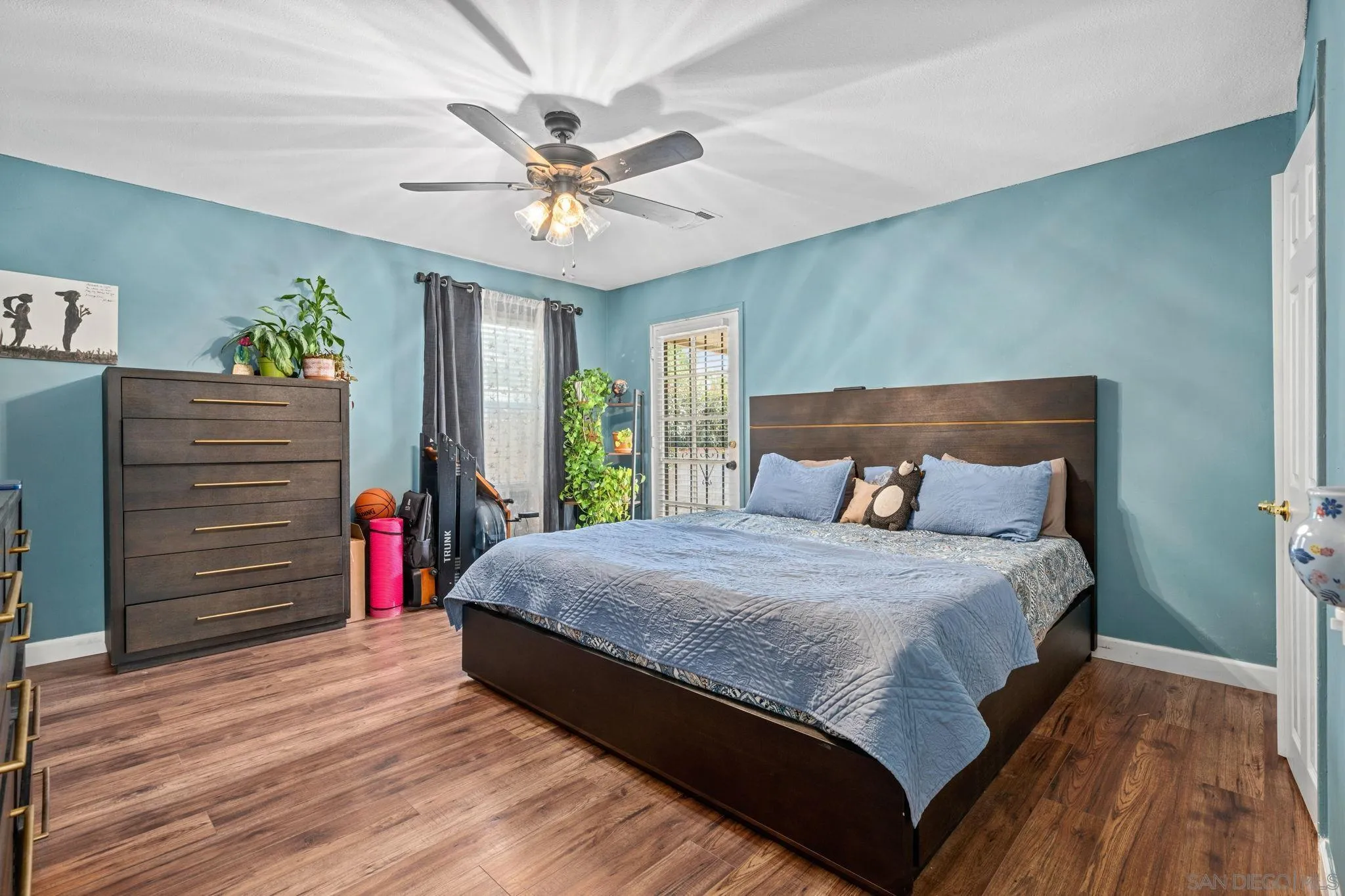 4544 Edgewood Place Riverside, CA 92506 - Photo 10 of 29 a bed sitting in a bedroom next to a window with a chandelier