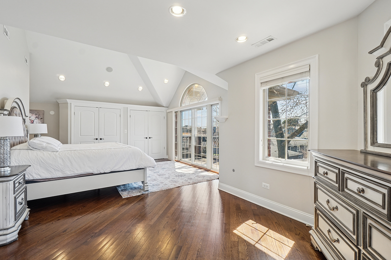 7039 Simpson Street Morton Grove, IL 60053 - Photo 13 of 24 a spacious bedroom with a large bed and a large window