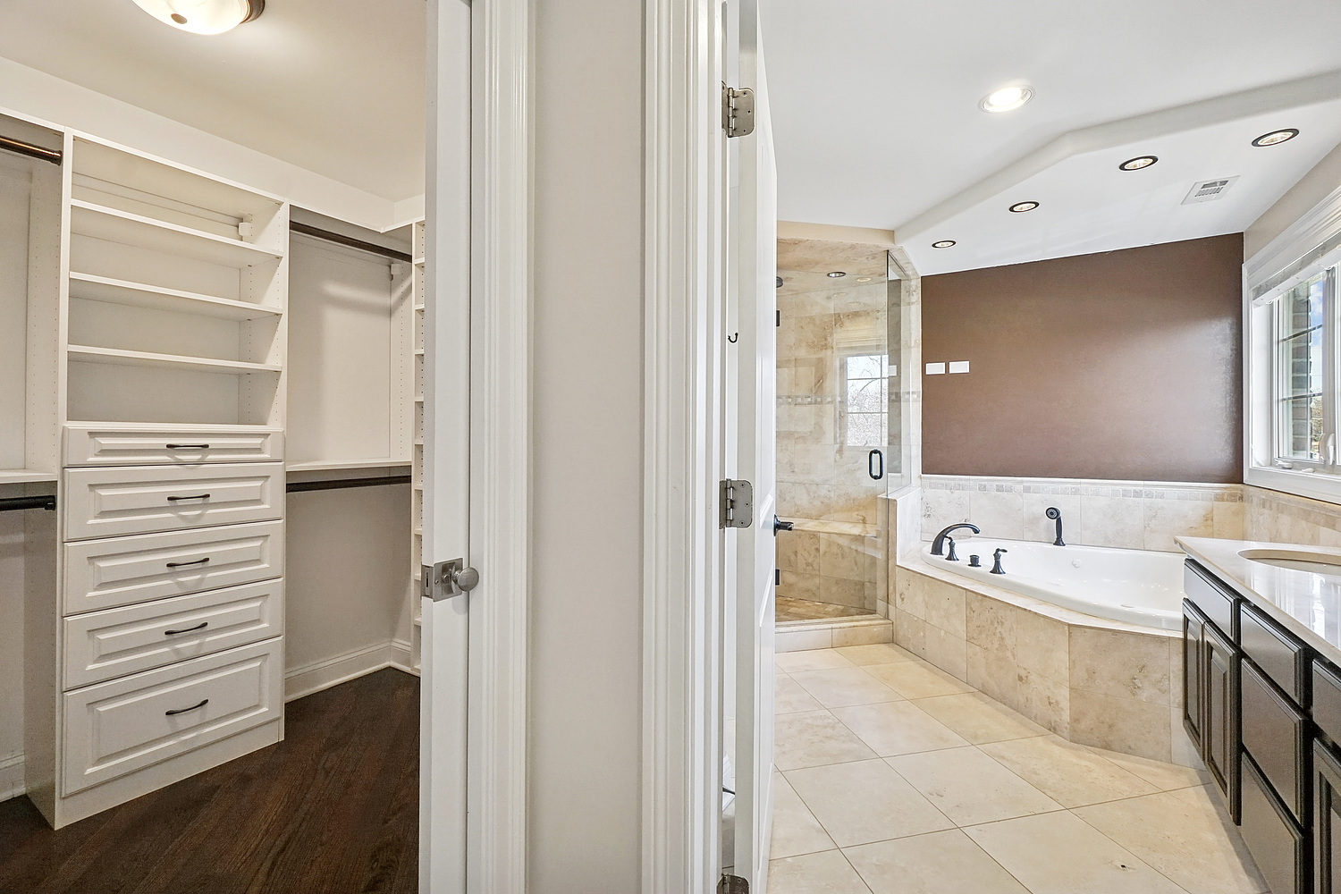 7039 Simpson Street Morton Grove, IL 60053 - Photo 15 of 24 a bathroom with a bathtub a double vanity sink and a shower