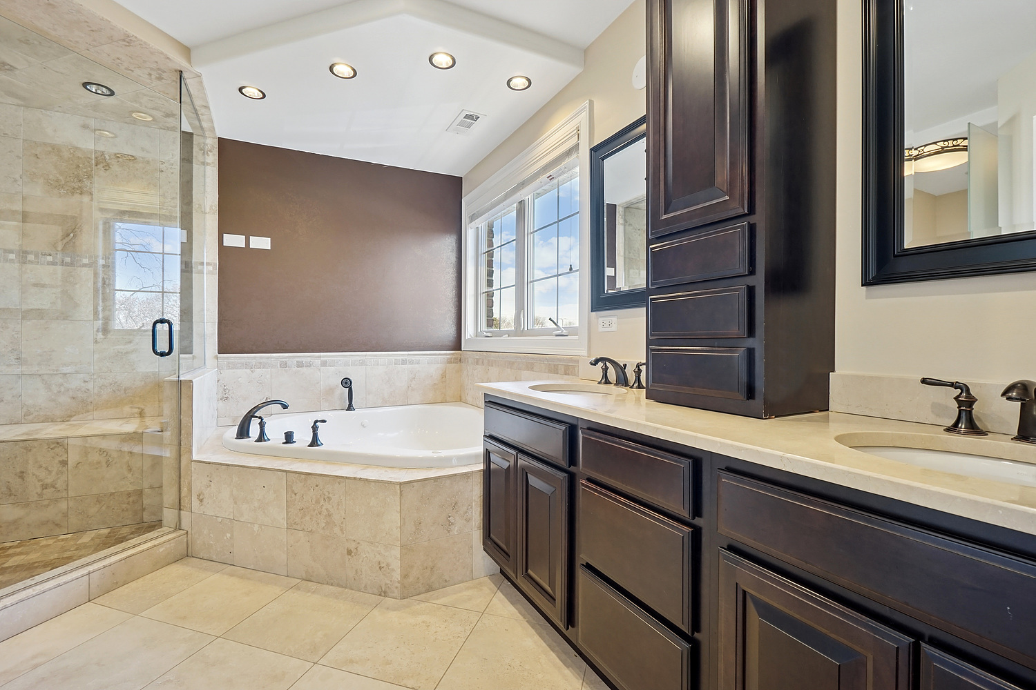 7039 Simpson Street Morton Grove, IL 60053 - Photo 16 of 24 a bathroom with a sink double vanity granite tub shower and a mirror