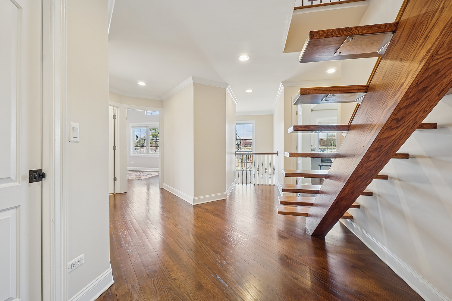 7039 Simpson Street Morton Grove, IL 60053 - Photo 18 of 24 a view of entryway with wooden floor and stairs