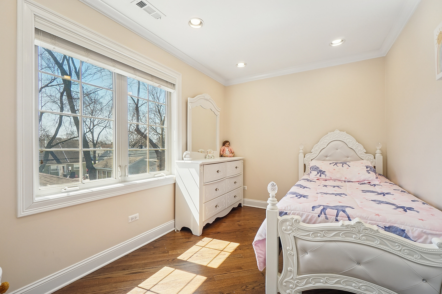 7039 Simpson Street Morton Grove, IL 60053 - Photo 19 of 24 a bedroom with a bed and a large window