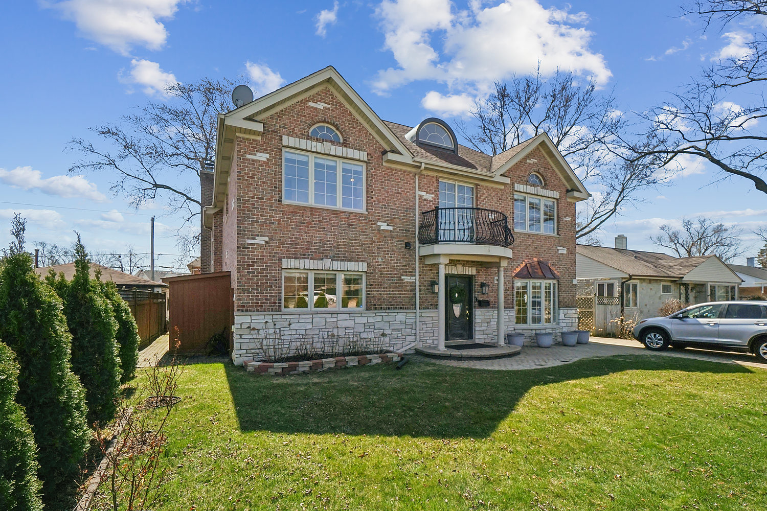 7039 Simpson Street Morton Grove, IL 60053 - Photo 3 of 24 a front view of a house with a yard and garage