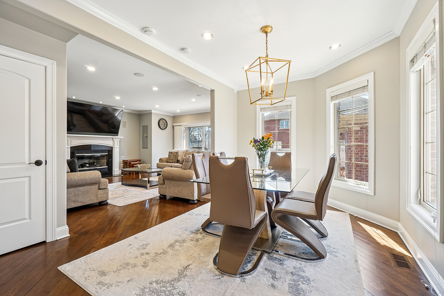 7039 Simpson Street Morton Grove, IL 60053 - Photo 8 of 24 a living room with furniture wooden floor and a chandelier