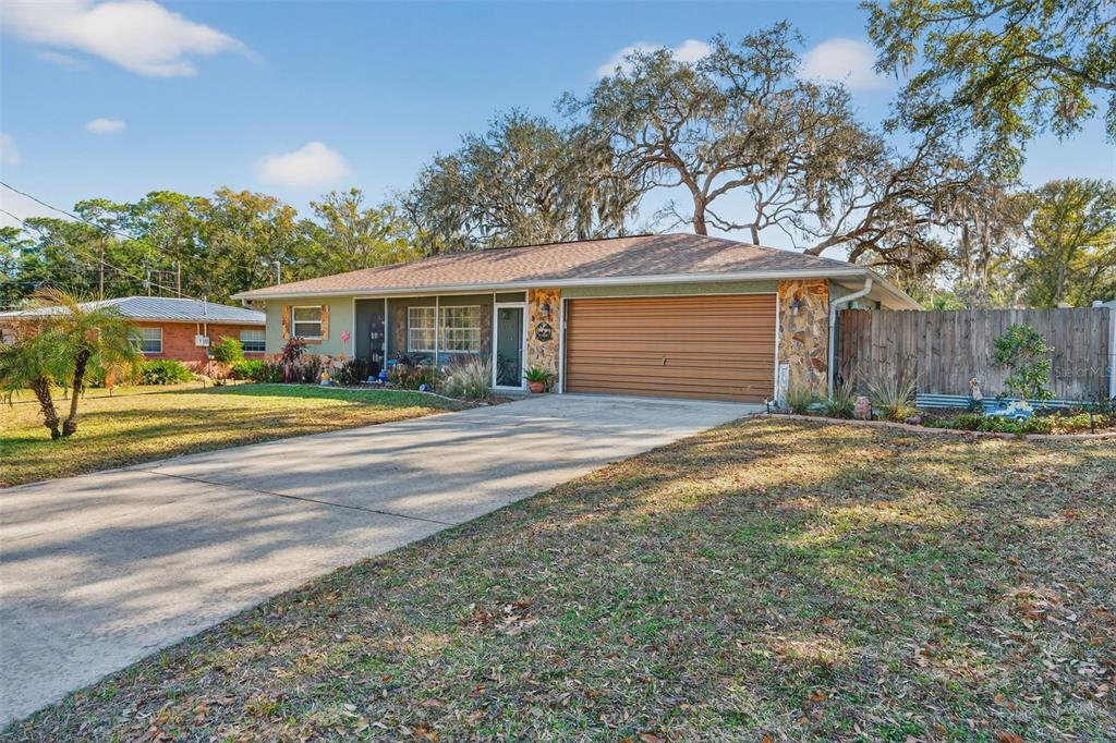 a front view of a house with a yard and outdoor seating