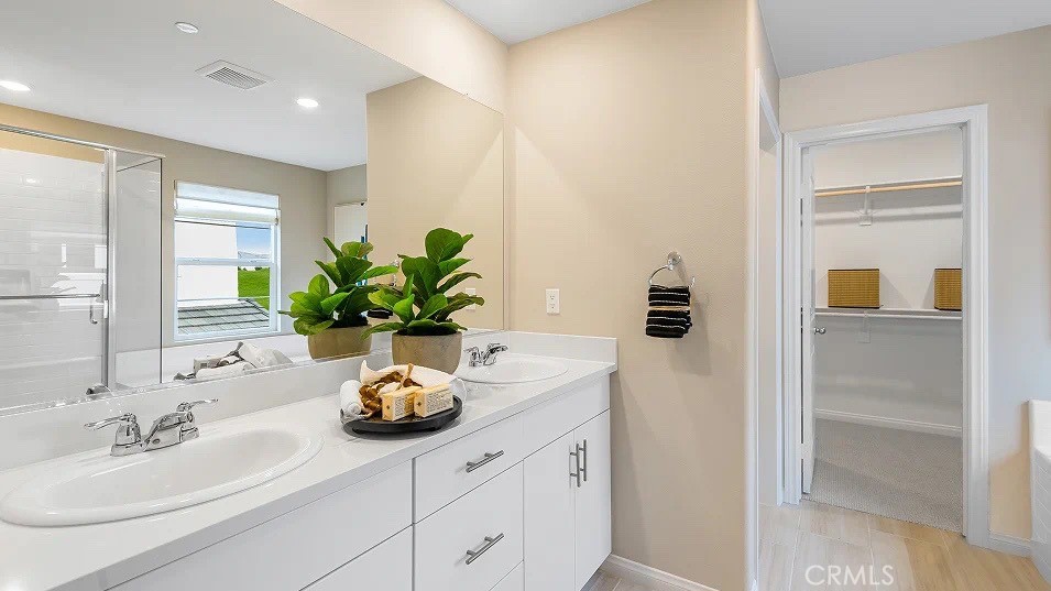 1658 Phantom Lane Rialto, CA 92376 - Photo 13 of 22 a bathroom with a sink a vanity and a mirror