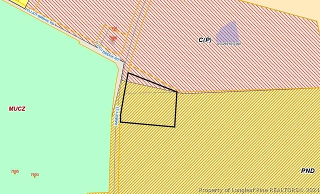 a view of a street with wooden fence