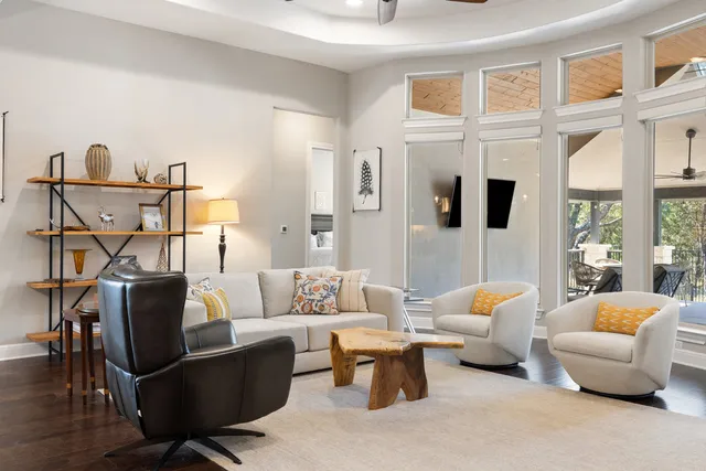 a living room with furniture and a chandelier
