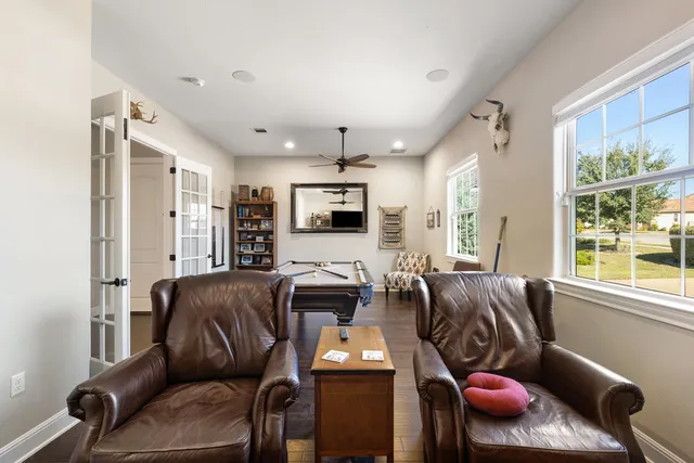 a living room with furniture fireplace and a large window