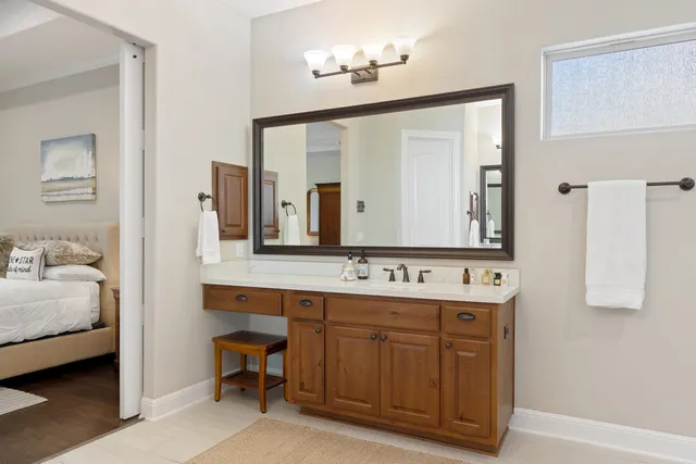 a en suite bathroom with a double vanity sink and a mirror