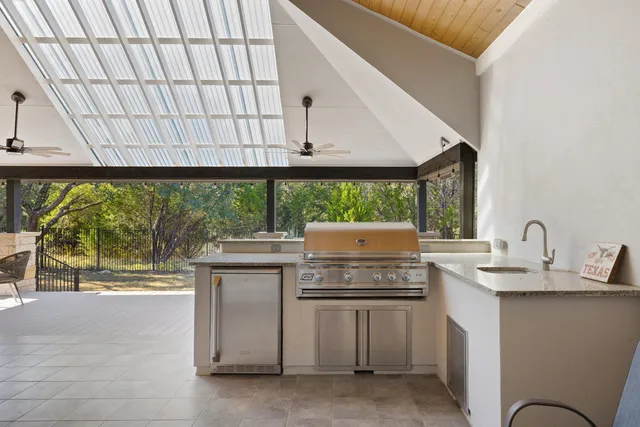 a kitchen with a stove and a white cabinets