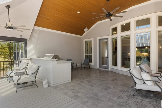 a view of a patio with table and chairs and a barbeque