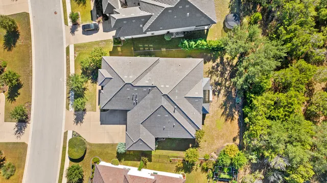 an aerial view of a house with swimming pool garden and patio