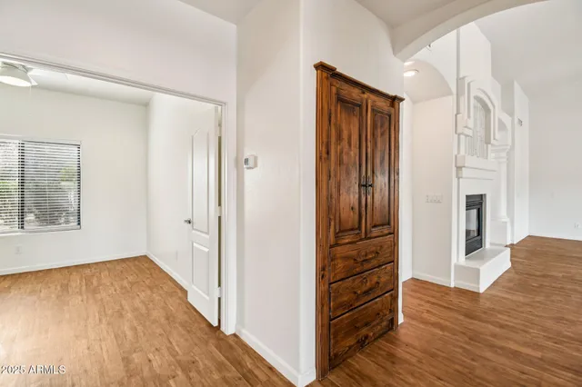 a view of empty room with wooden floor