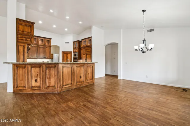 a kitchen with stainless steel appliances granite countertop a stove and a refrigerator