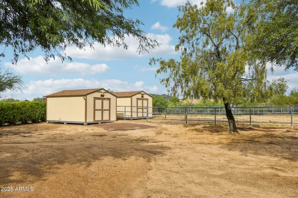 a front view of a house with yard and outdoor seating