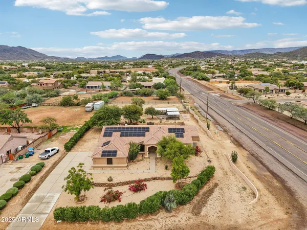 an aerial view of a house with a yard basket ball court and outdoor seating